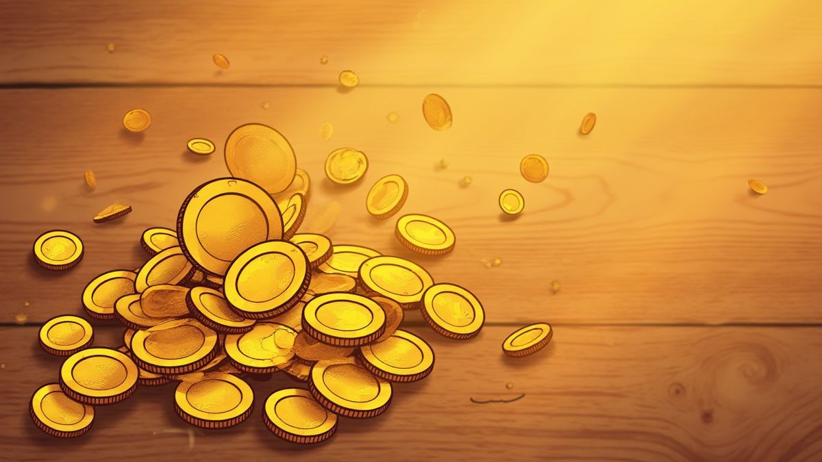 Monedas doradas dispersas sobre una superficie de madera.