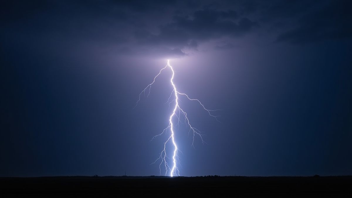 A glowing lightning bolt hitting the ground in a dark sky.